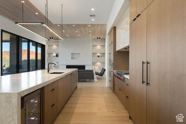 2655 W Shoshoni Trl, St George, UT 84770 - kitchen featuring beverage cooler, a spacious island, modern cabinets, open floor plan, and a sink