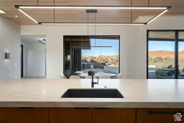 2655 W Shoshoni Trl, St George, UT 84770 - kitchen with brown cabinetry, modern cabinets, a sink, and a mountain view