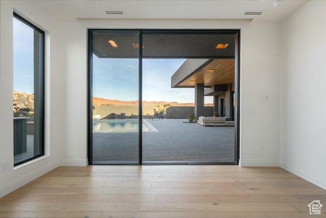 2655 W Shoshoni Trl, St George, UT 84770 - doorway to outside with a mountain view, light wood finished floors, visible vents, and baseboards