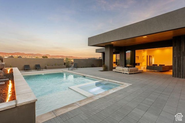 2655 W Shoshoni Trl, St George, UT 84770 - view of pool with an outdoor living space with a fire pit, a patio area, a pool with connected hot tub, and fence