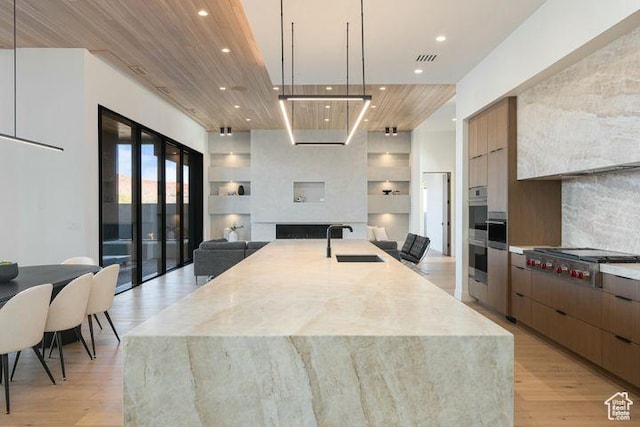 2655 W Shoshoni Trl, St George, UT 84770 - kitchen with stainless steel gas stovetop, hanging light fixtures, a sink, and modern cabinets