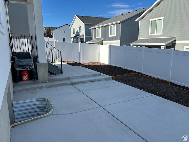 view of patio / terrace with a fenced backyard and a residential view