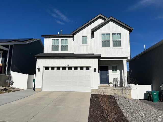 modern farmhouse featuring board and batten siding, concrete driveway, and an attached garage