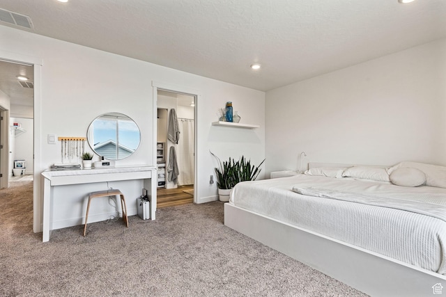 bedroom with baseboards, visible vents, a textured ceiling, carpet flooring, and recessed lighting