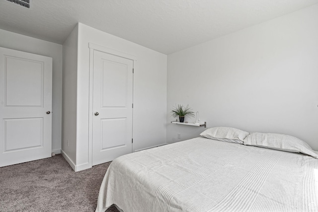 carpeted bedroom featuring visible vents and baseboards