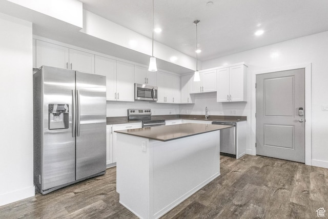 875 S Depot St Unit C316, Clearfield, UT 84015 - kitchen with stainless steel appliances, white cabinetry, hanging light fixtures, a center island, and dark countertops