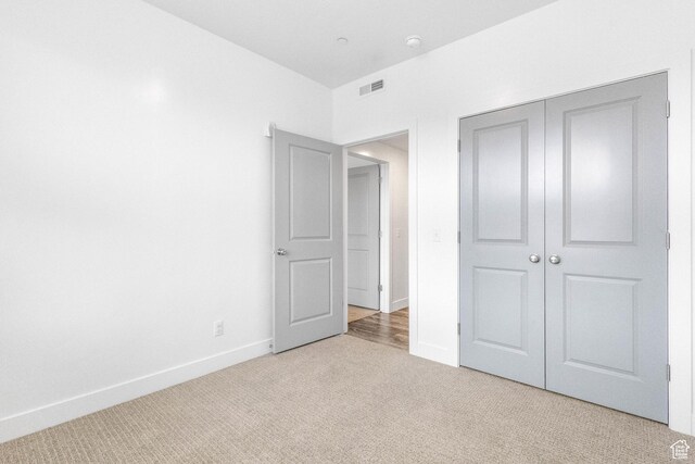 875 S Depot St Unit C316, Clearfield, UT 84015 - unfurnished bedroom featuring light carpet, a closet, visible vents, and baseboards
