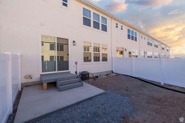 107 W 1360 N, Nephi, UT 84648 - back of property at dusk with a patio, fence private yard, and stucco siding
