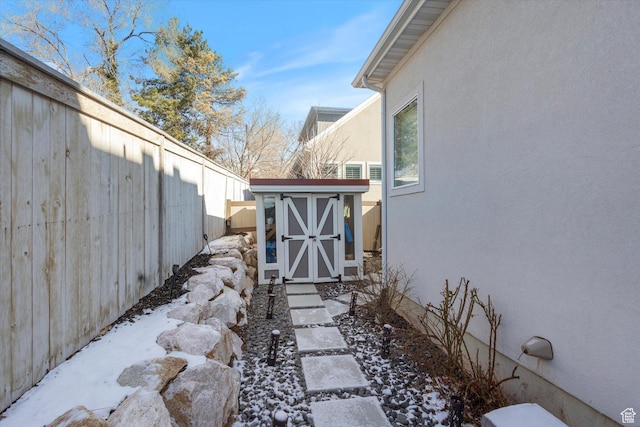 2321 E John Holladay Ct S, Holladay, UT 84117 - yard covered in snow with a fenced backyard, a storage unit, and an outbuilding