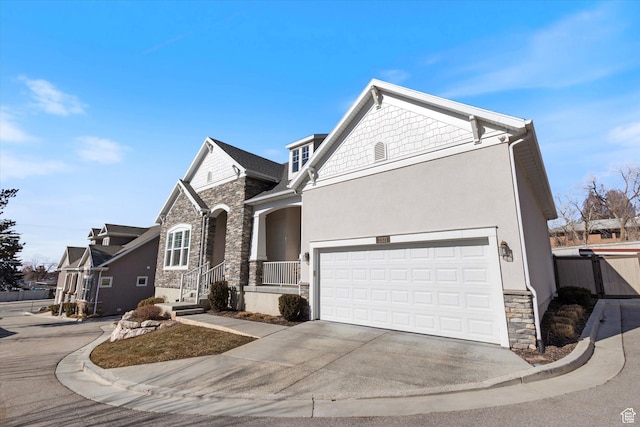 2321 E John Holladay Ct S, Holladay, UT 84117 - view of front of house featuring stone siding, driveway, an attached garage, and stucco siding