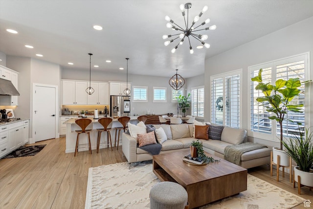 2321 E John Holladay Ct S, Holladay, UT 84117 - living room with recessed lighting, light wood-type flooring, and an inviting chandelier