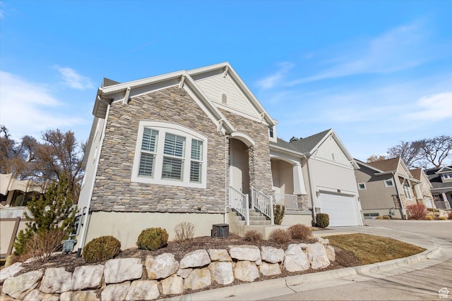2321 E John Holladay Ct S, Holladay, UT 84117 - view of front of property with a residential view, stone siding, driveway, and an attached garage
