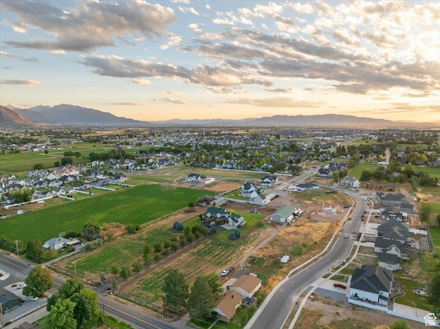 aerial view at dusk featuring a mountain view
