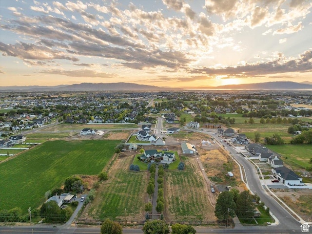 aerial view at dusk featuring a mountain view