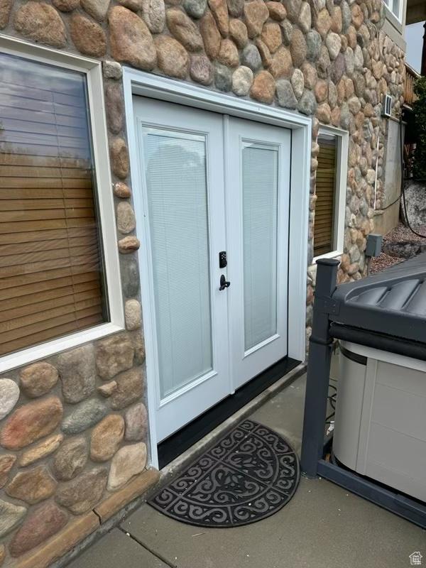 property entrance with stone siding