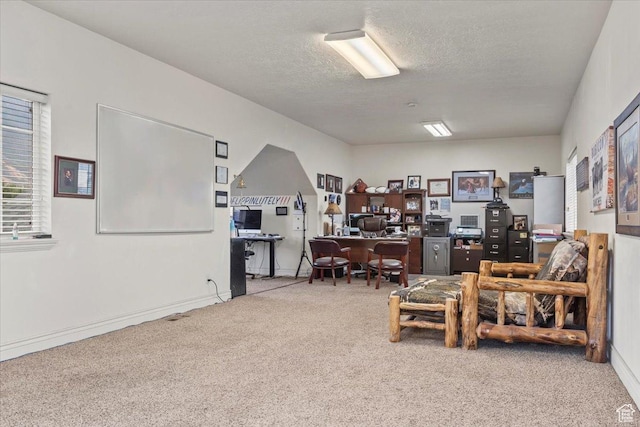 office area with a textured ceiling and carpet flooring