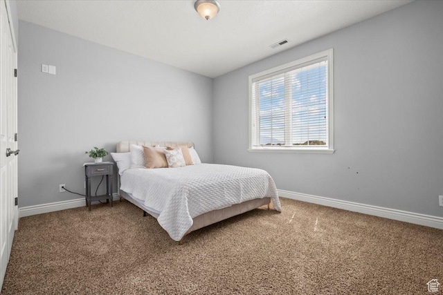 carpeted bedroom featuring visible vents and baseboards