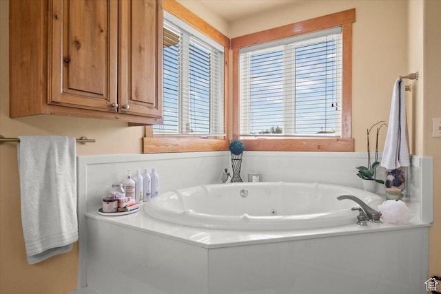 bathroom with a tub with jets