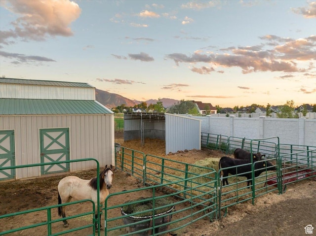 view of horse barn with a mountain view