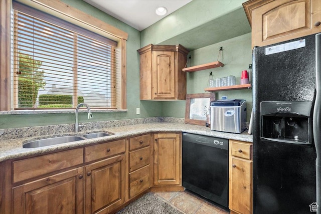 kitchen featuring brown cabinetry, a sink, black appliances, and open shelves