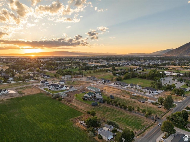 aerial view at dusk featuring a mountain view