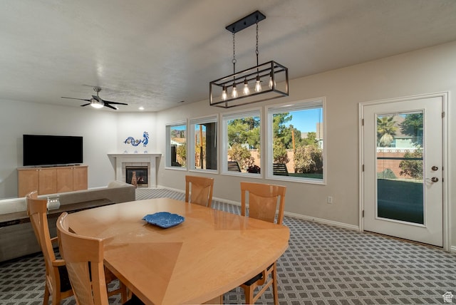 1779 N 2330th Cir W, St George, UT 84770 - dining space with a ceiling fan, baseboards, carpet flooring, and a tiled fireplace