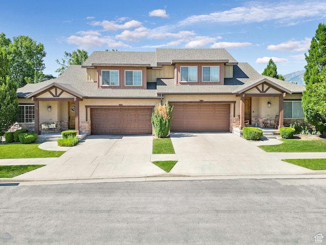 1429 E Chateau Ridge Way S, Sandy, UT 84092 - view of front facade with stucco siding, a shingled roof, a garage, stone siding, and driveway