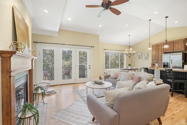 1429 E Chateau Ridge Way S, Sandy, UT 84092 - living area featuring a tile fireplace, vaulted ceiling, light wood-style flooring, and ceiling fan with notable chandelier