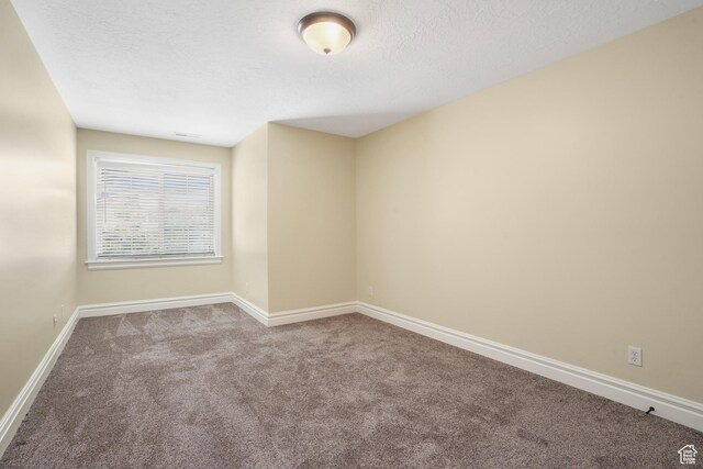 1429 E Chateau Ridge Way S, Sandy, UT 84092 - empty room featuring carpet flooring, a textured ceiling, and baseboards