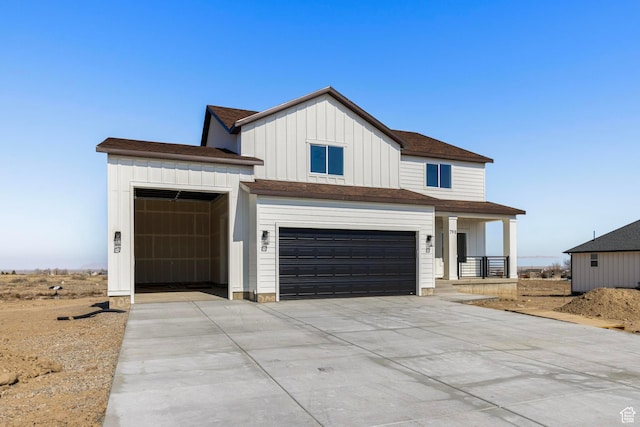 view of front of property featuring a garage, driveway, board and batten siding, and roof with shingles