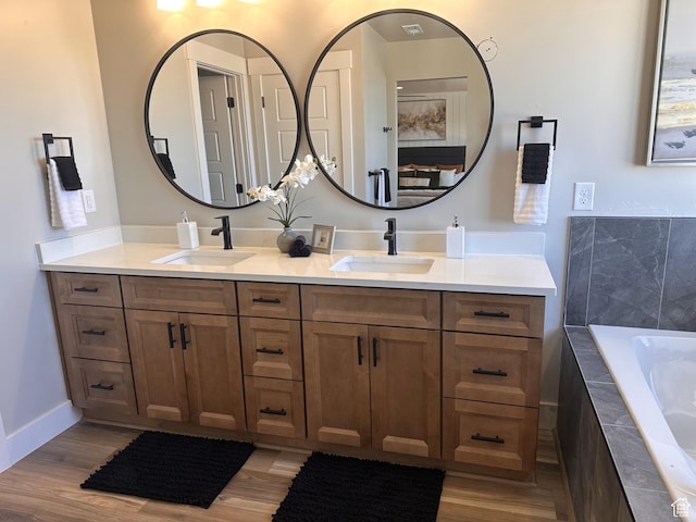 798 W Clark St N, Grantsville, UT 84029 - full bathroom featuring double vanity, wood finished floors, and a relaxing tiled tub