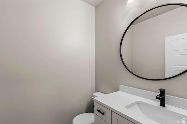 half bath featuring toilet and vanity