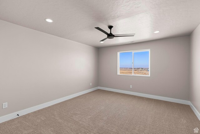carpeted empty room featuring recessed lighting, visible vents, a ceiling fan, a textured ceiling, and baseboards
