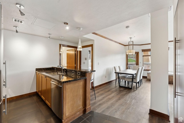 3720 N Sundial Ct Unit C207, Park City, UT 84098 - kitchen with a sink, dishwasher, baseboards, a peninsula, and ornamental molding