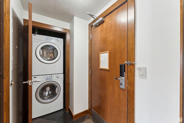 3720 N Sundial Ct Unit C207, Park City, UT 84098 - laundry area with estacked washer and dryer, tile patterned floors, and baseboards