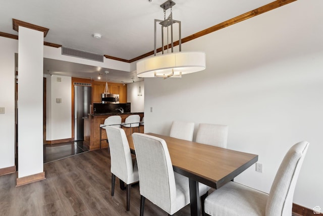 3720 N Sundial Ct Unit C207, Park City, UT 84098 - dining area featuring ornamental molding and dark wood-type flooring