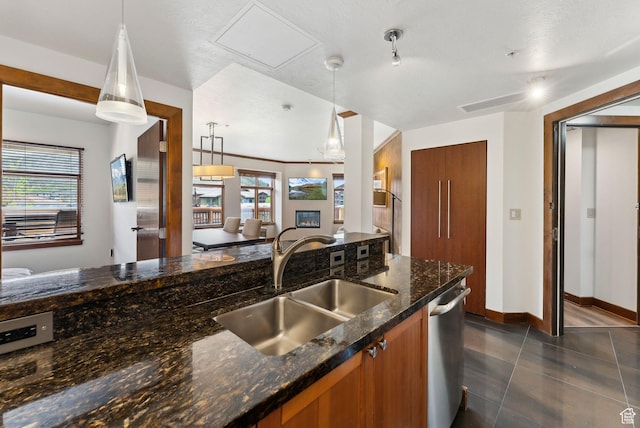 3720 N Sundial Ct Unit C207, Park City, UT 84098 - kitchen with brown cabinetry, a sink, dishwasher, hanging light fixtures, and dark stone counters