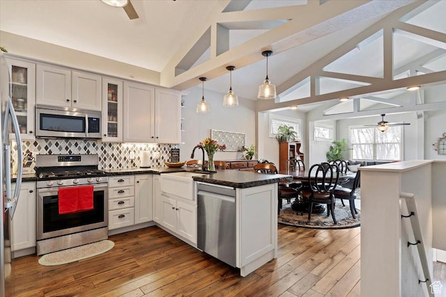 4337 N 2900 E, Liberty, UT 84310 - kitchen featuring lofted ceiling with beams, a peninsula, a ceiling fan, and stainless steel appliances