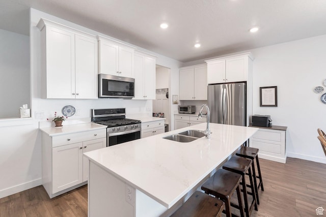 kitchen featuring appliances with stainless steel finishes, white cabinets, and light countertops