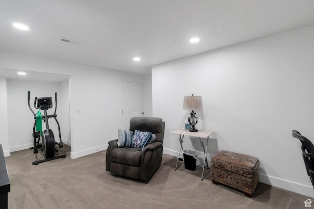sitting room with baseboards, light colored carpet, visible vents, and recessed lighting