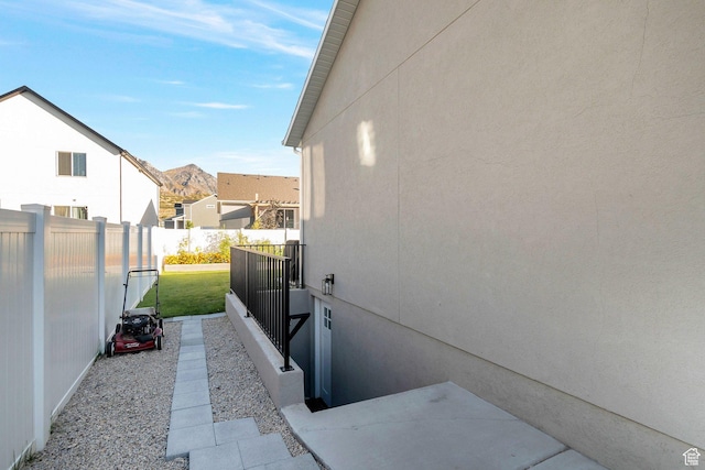 view of side of home with a residential view and a fenced backyard