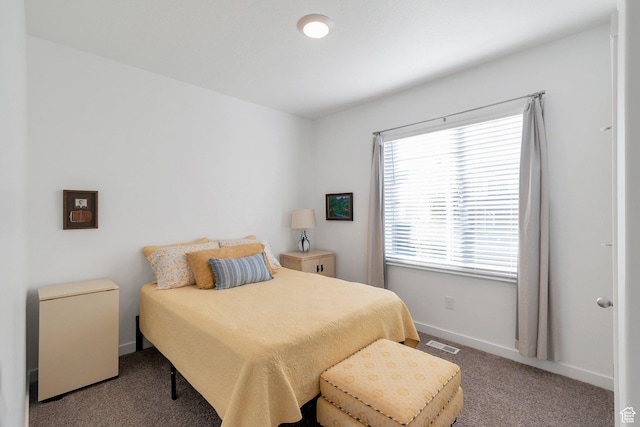 bedroom with carpet floors, visible vents, and baseboards