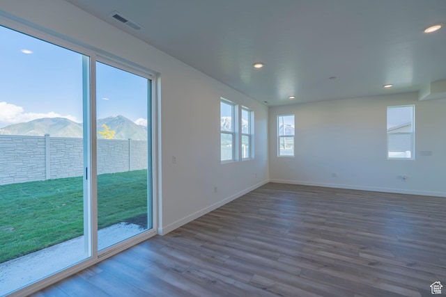 1644 N 800 W, Salem, UT 84653 - spare room with dark wood-style floors, a mountain view, baseboards, and recessed lighting