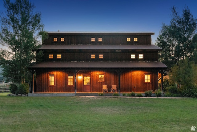 703 River Rd, Midway, UT 84049 - back of house with a yard, covered porch, and board and batten siding