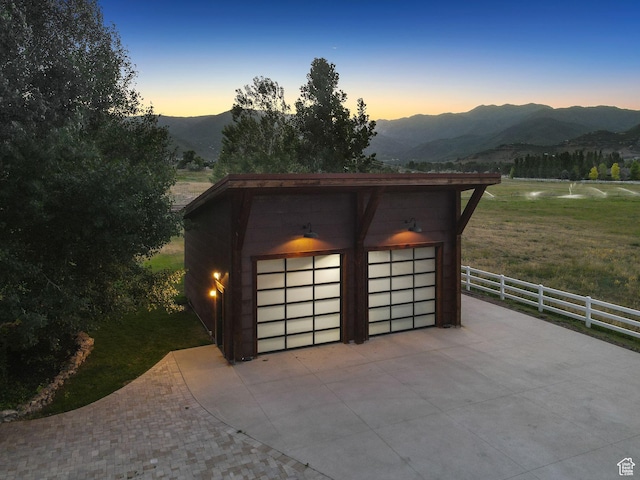 703 River Rd, Midway, UT 84049 - garage at dusk featuring a mountain view and a garage