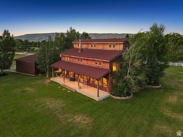 703 River Rd, Midway, UT 84049 - back of house with a patio area, a mountain view, a lawn, and a metal roof