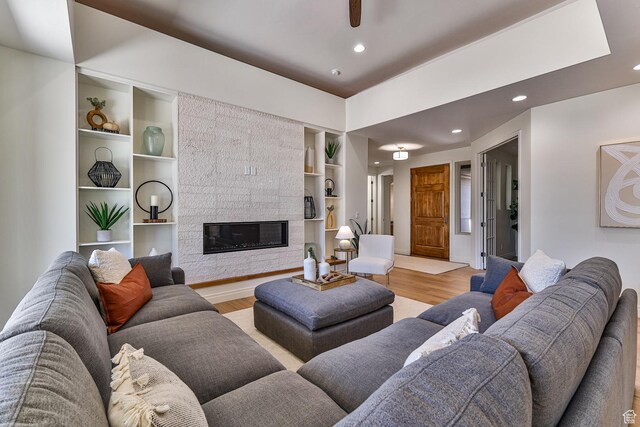 38 S 1840 W, St George, UT 84770 - living room with built in shelves, a tile fireplace, recessed lighting, baseboards, and light wood-style floors