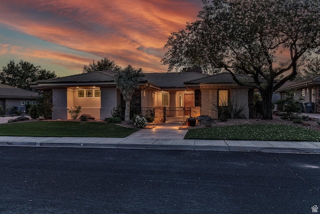 view of front of home featuring a front yard and stucco siding