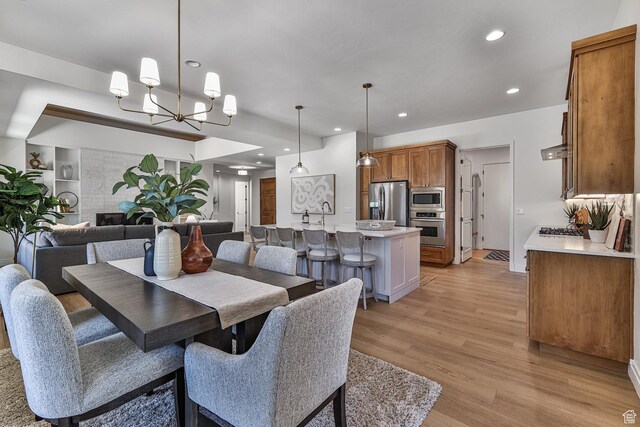 38 S 1840 W, St George, UT 84770 - dining area featuring light wood-type flooring, a notable chandelier, a fireplace, and recessed lighting