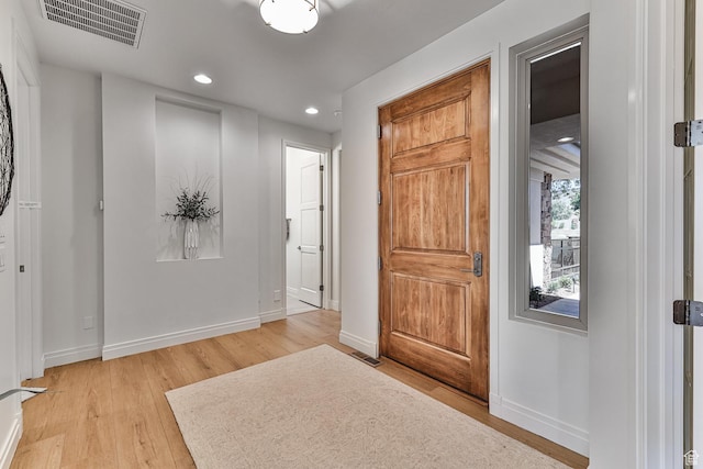 entryway with recessed lighting, visible vents, light wood-style flooring, and baseboards